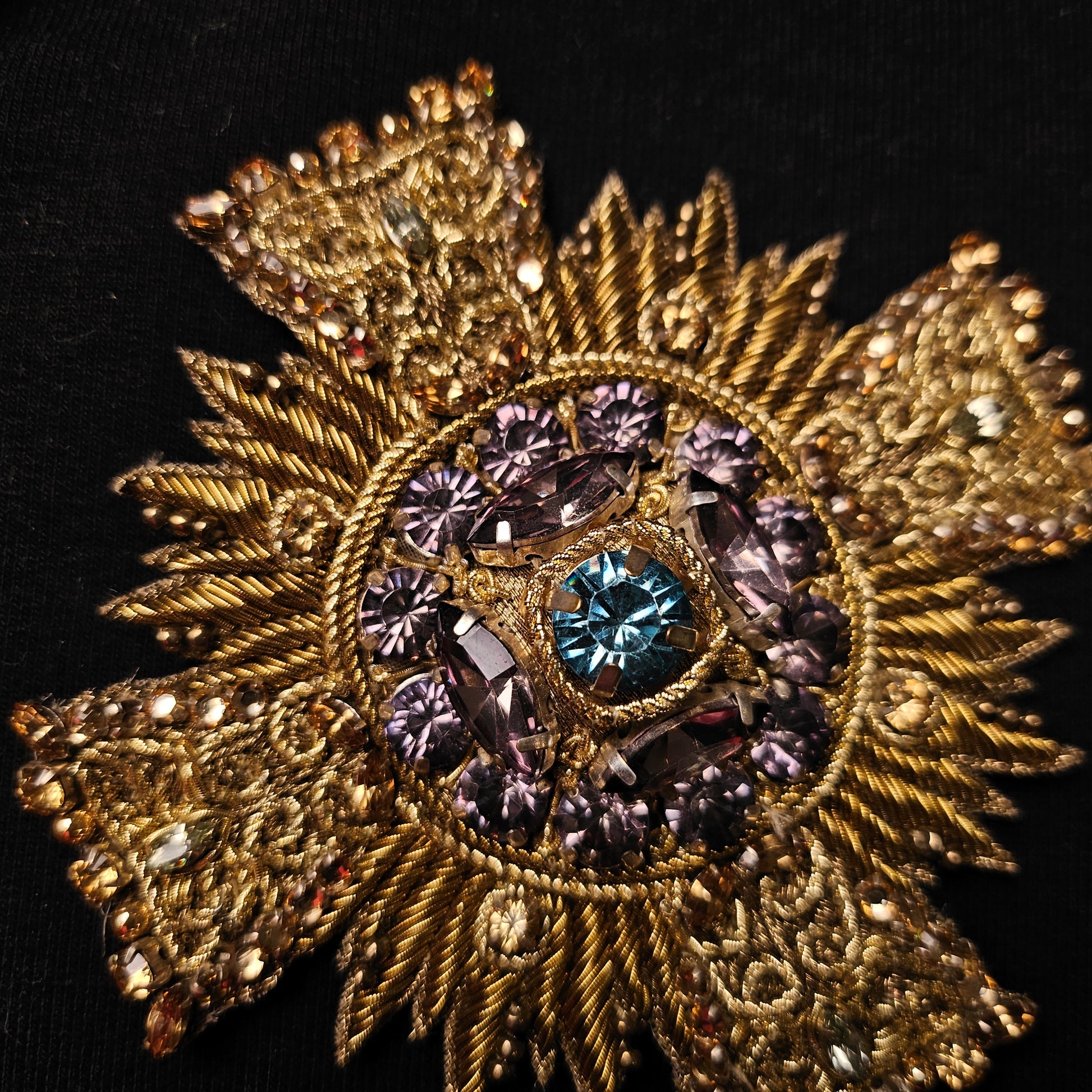D&G gold metallic embroidered patch with purple and blue crystal embellishments, 9x9cm.