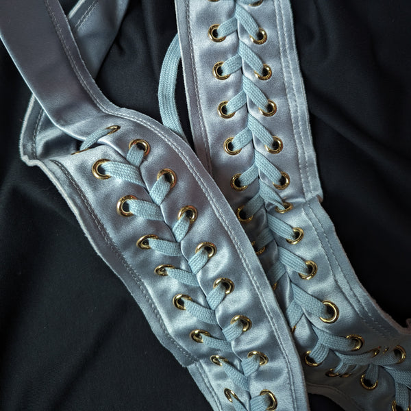 Light blue D&G deadstock satin corset lacing with gold eyelets on black fabric.