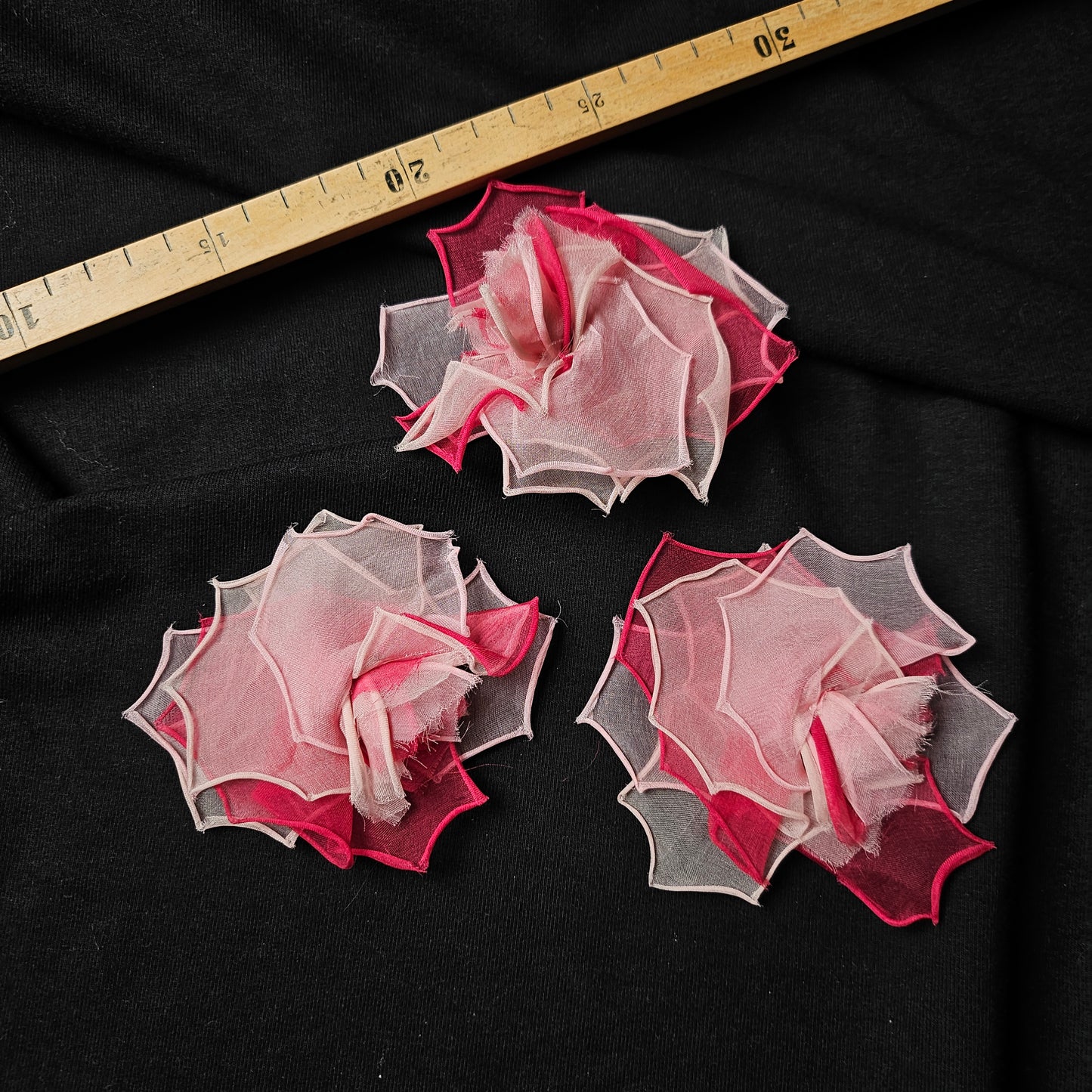 Three D&G rose and tulle patches, 10x10 cm, in shades of pink and white, on black fabric.