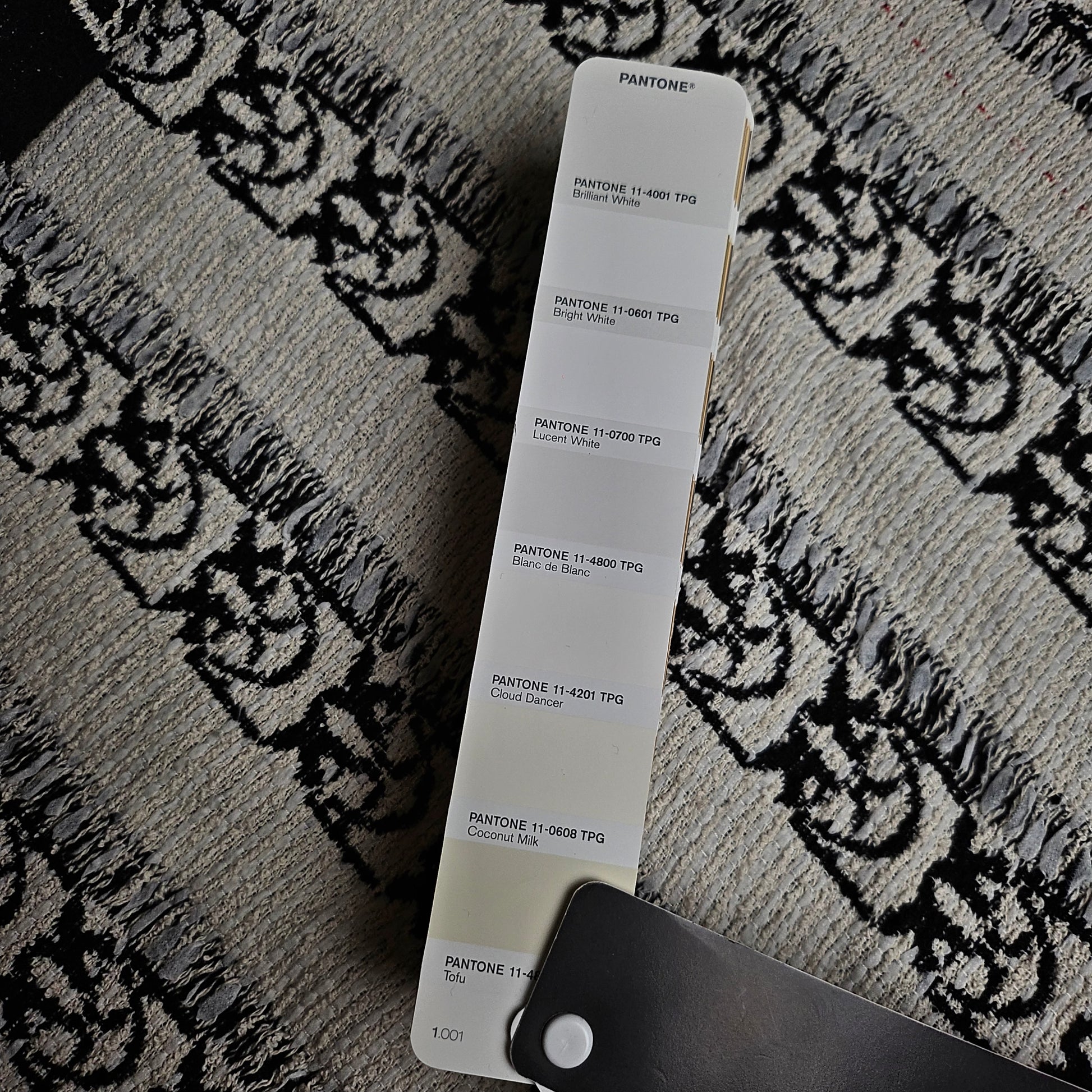 Pinko deadstock cotton tweed fabric, 150cm wide, with black Love Birds pattern and Pantone Coconut Milk swatch.