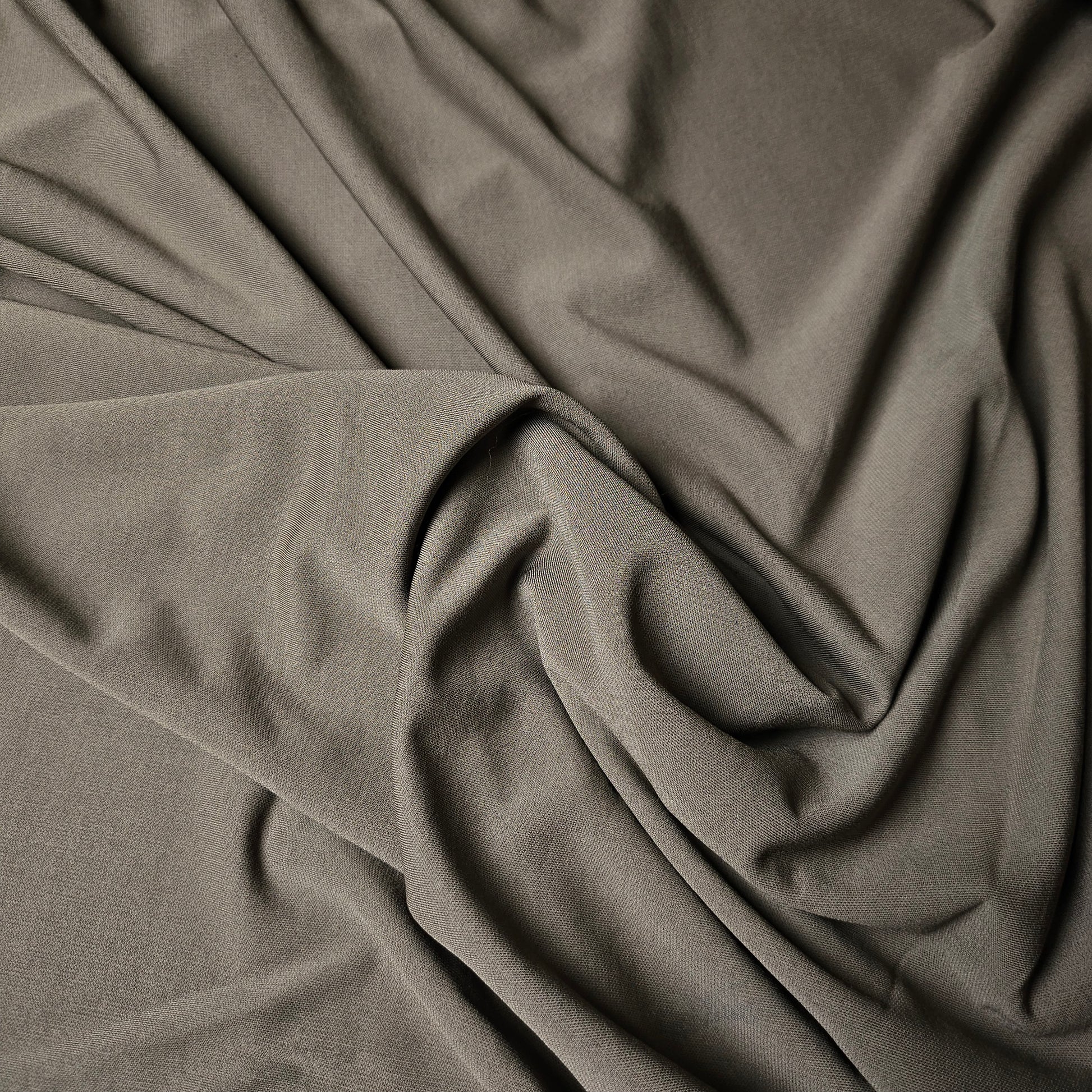 Mud brown viscose jersey crepe fabric with elegant drape and fine texture.