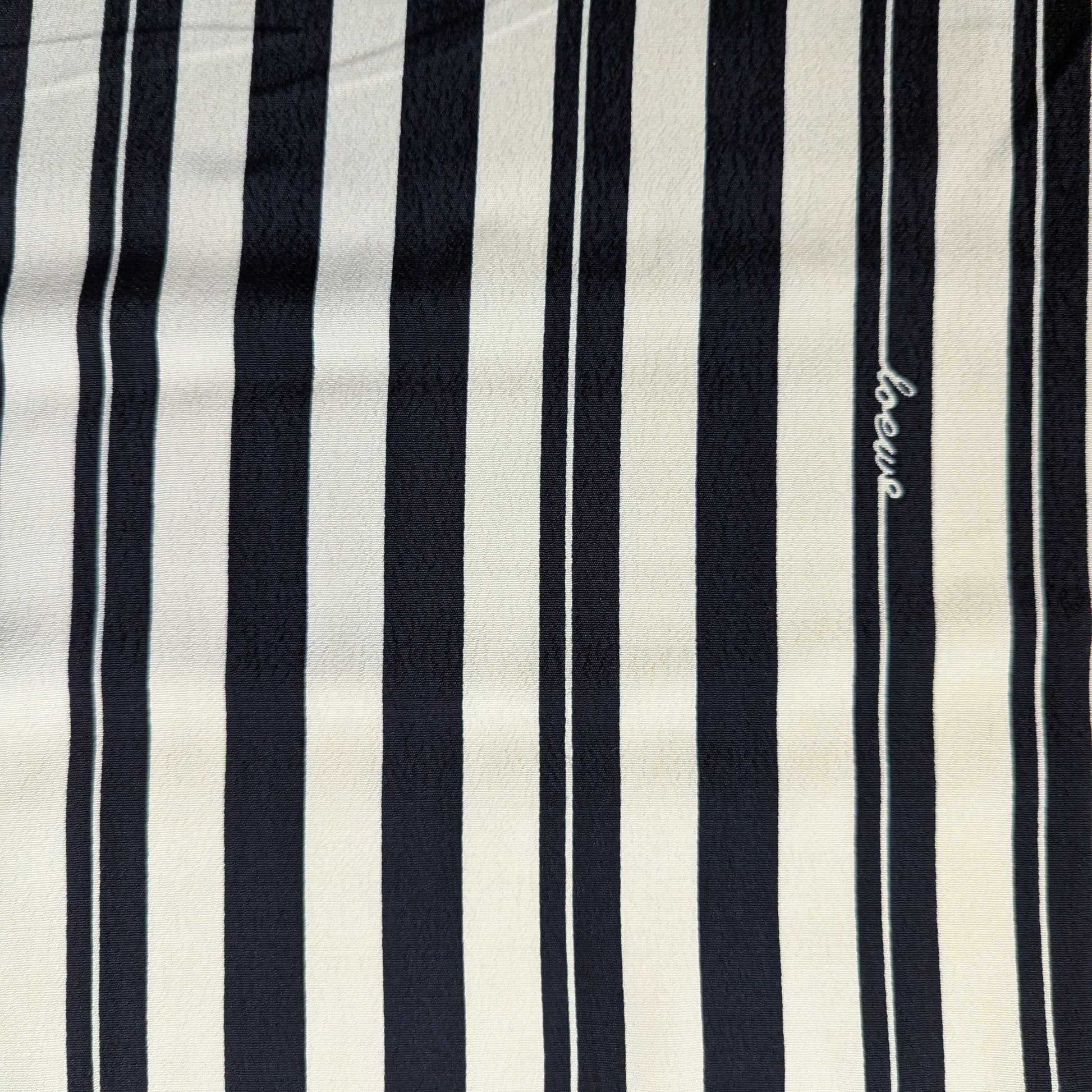 Viskosecrepe fabric, 140cm wide, with black and off-white vertical stripes and "Loewe" embroidered.