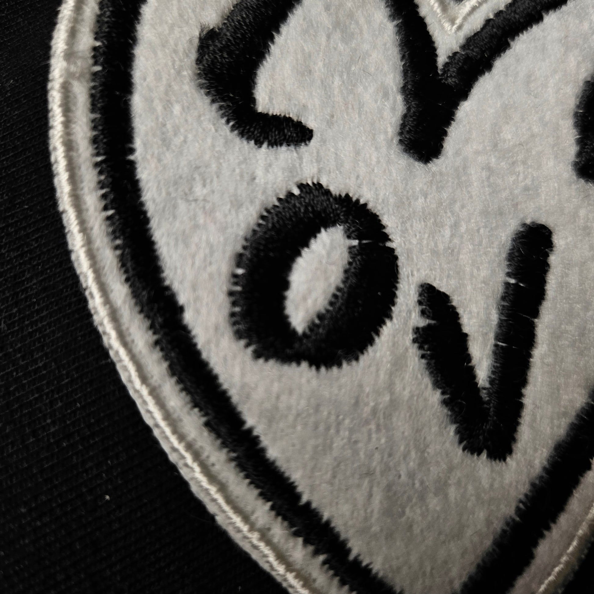 D&G "Love" heart patch, 8x8cm, white embroidered felt with black lettering and border.
