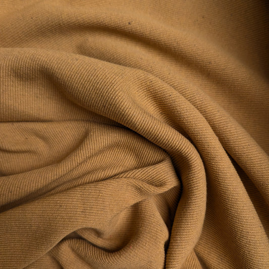 Mustard melange rib knit deadstock fabric, 115 cm wide, with a visible knit structure and soft folds.