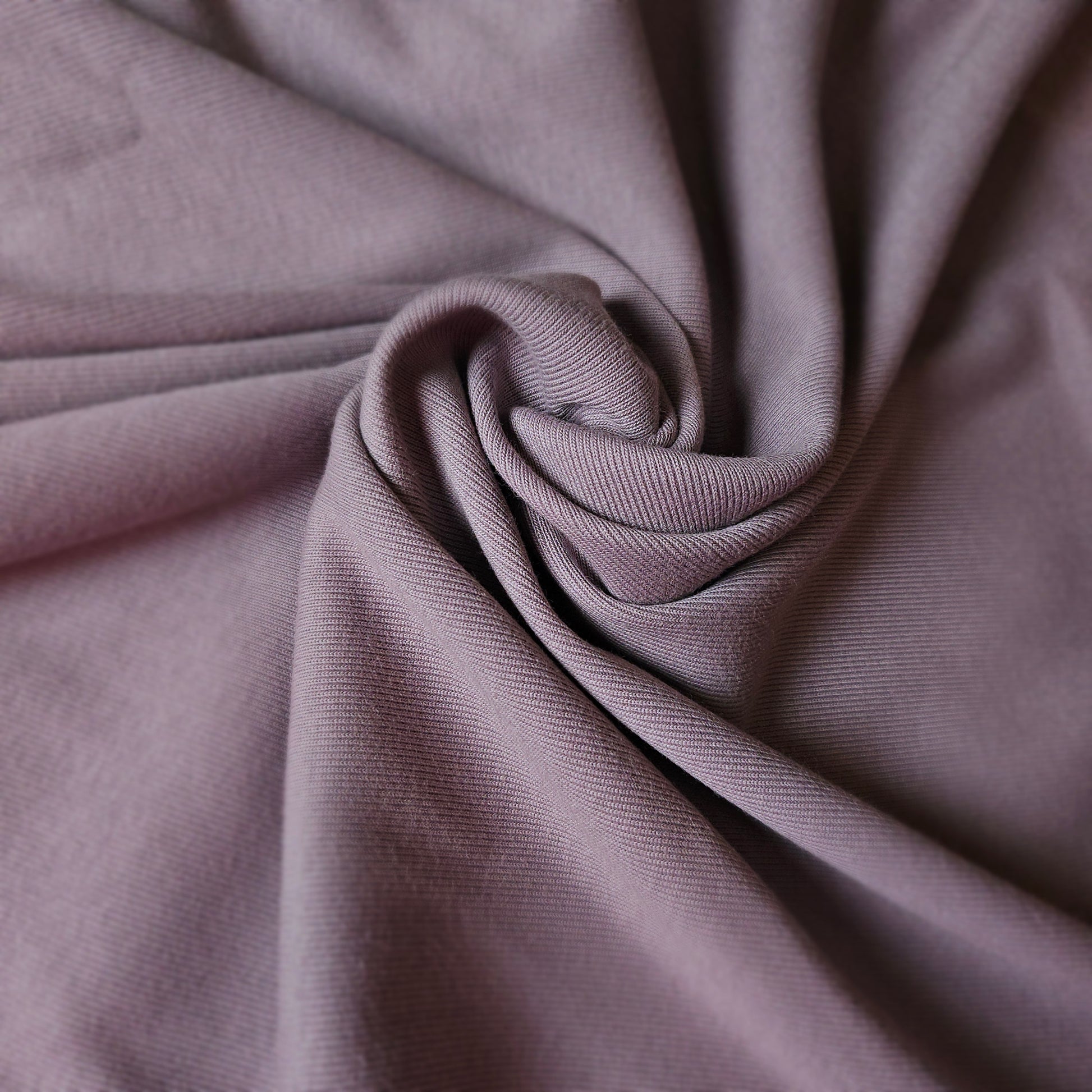 Malve Pantone cotton rib knit fabric, deadstock, with a visible ribbed texture and soft folds.