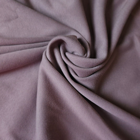 Malve Pantone cotton rib knit fabric, deadstock, with a visible ribbed texture and soft folds.