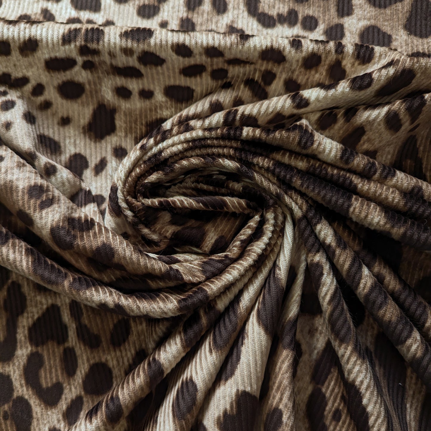 D&G deadstock corduroy fabric, 150cm wide, featuring a brown leopard print and subtle ribbing.