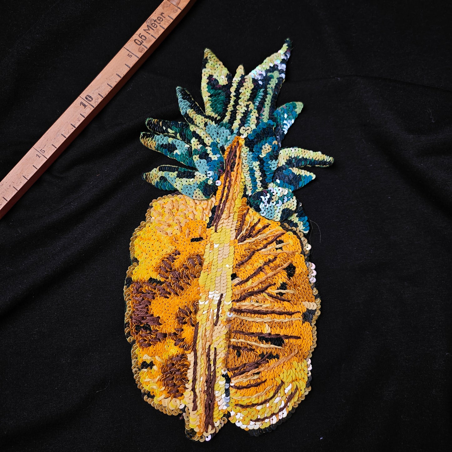 D&G sequin pineapple patch, 15x30cm, with yellow, gold, green, and blue paillettes on black fabric.
