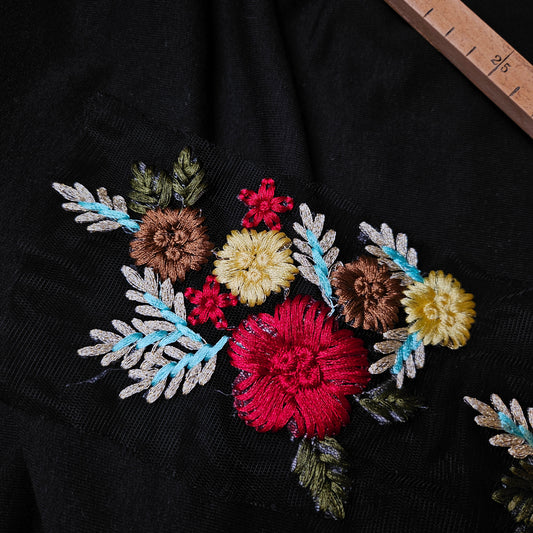 D&G floral embroidery patch on black fabric, featuring colorful red, yellow, and brown flowers with blue and green leaves.