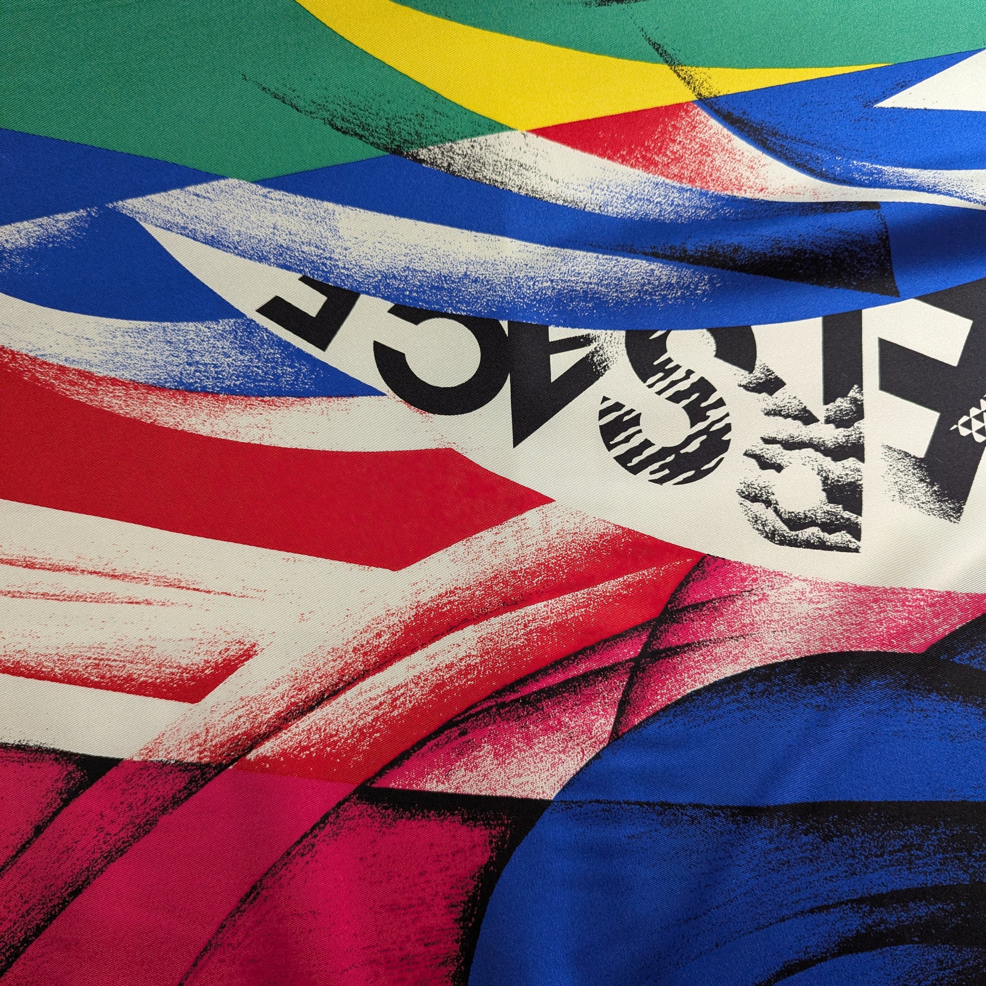 Versace deadstock silk fabric with a vibrant, abstract XXL print in red, blue, green, yellow, and black.