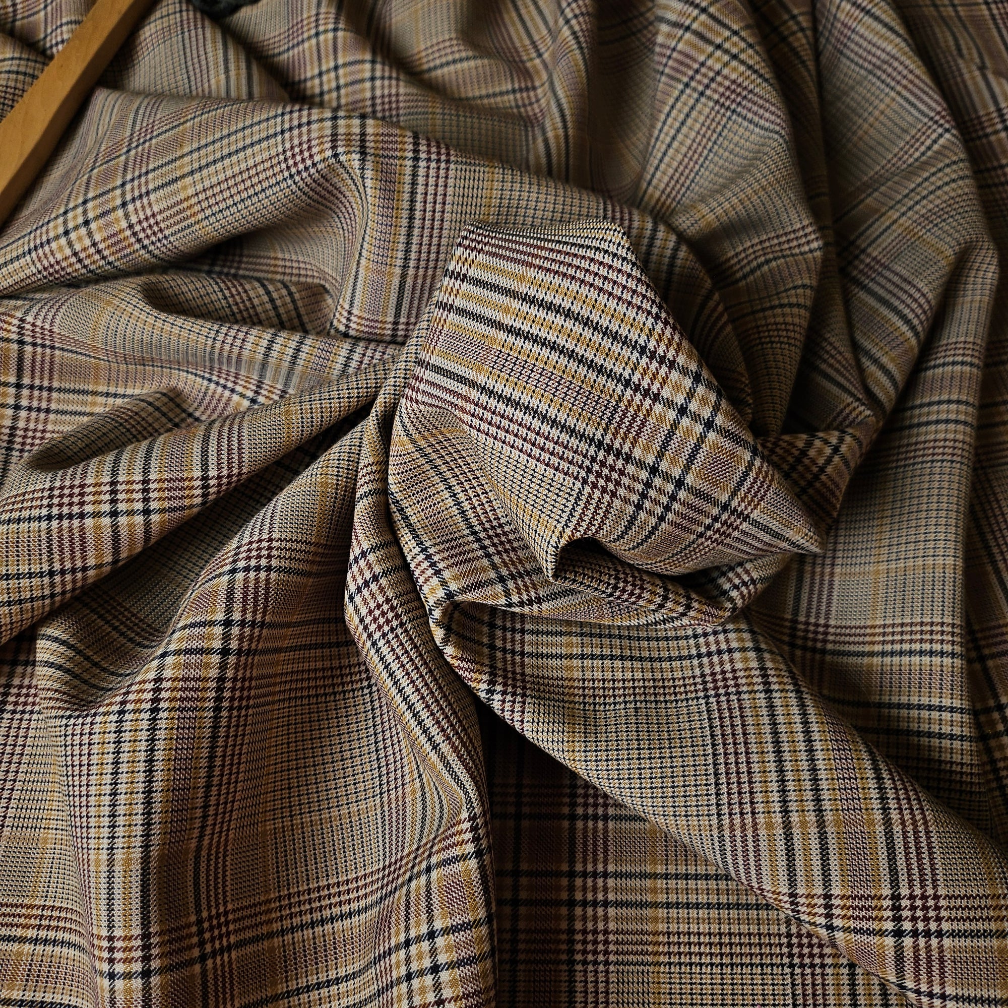 G*cc* deadstock woven wool fabric: beige Prince of Wales check pattern with brown, black, and red.