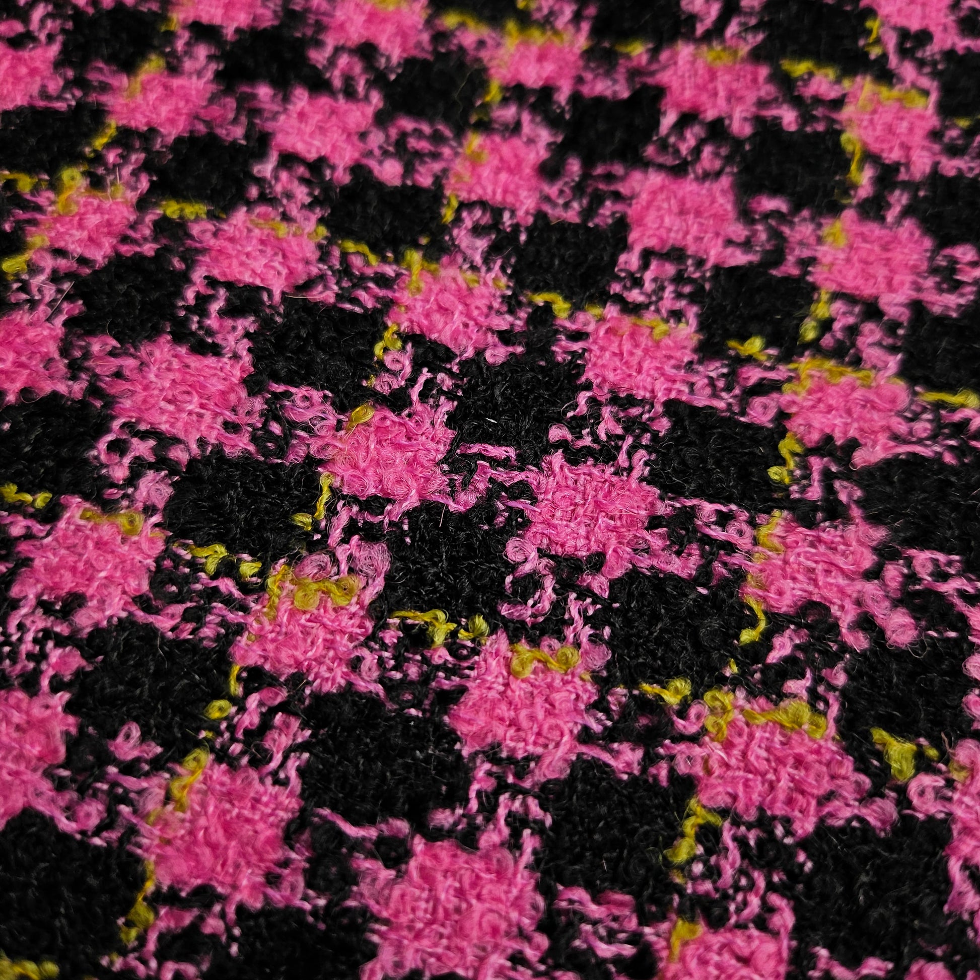 Super pink and black houndstooth tweed wool fabric with subtle yellow flecks.