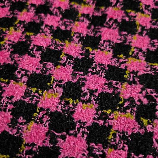Super pink and black houndstooth tweed wool fabric with subtle yellow flecks.
