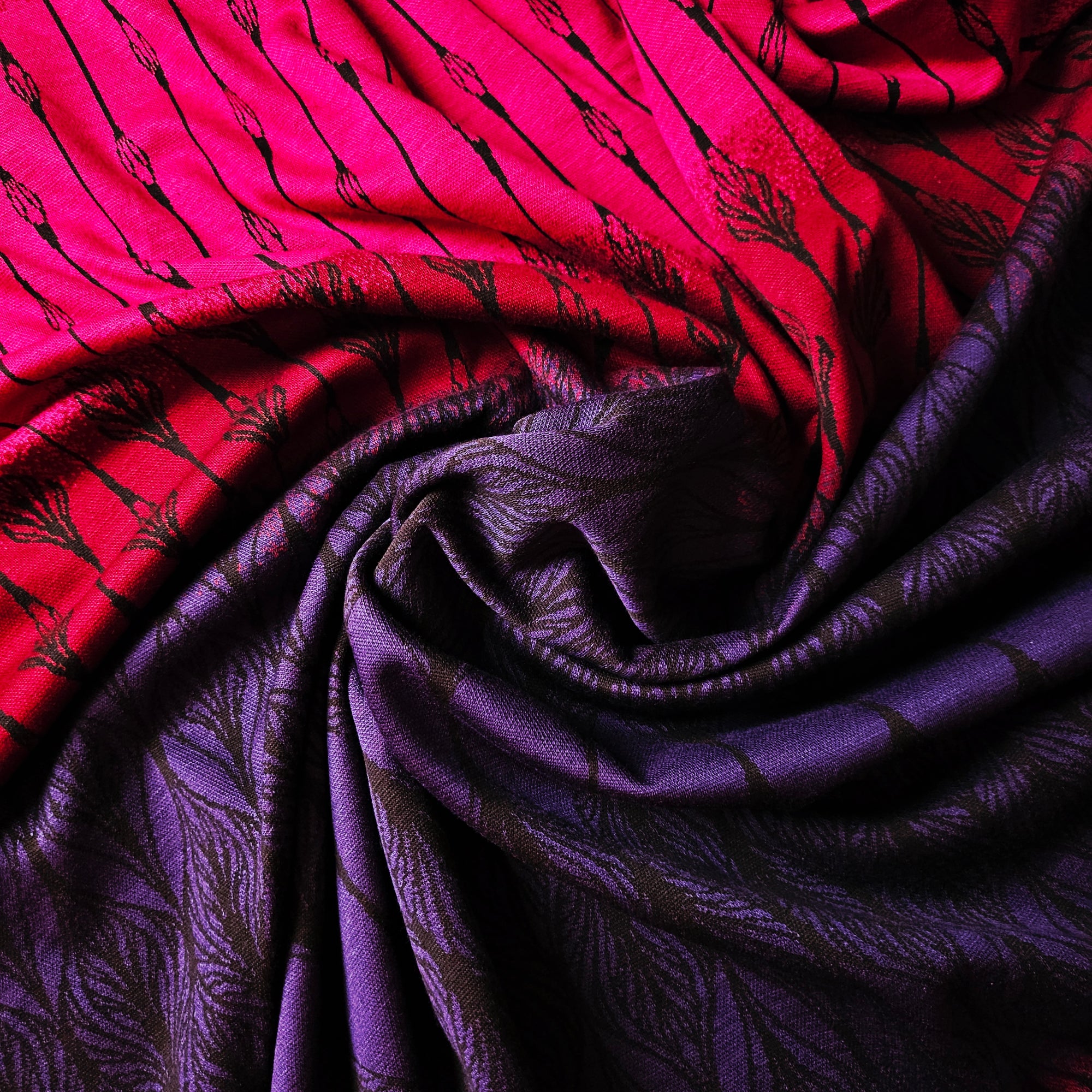 Vibrant pink to purple gradient doubleface jersey cotton blend fabric with a black leaf pattern, soft and elastic.