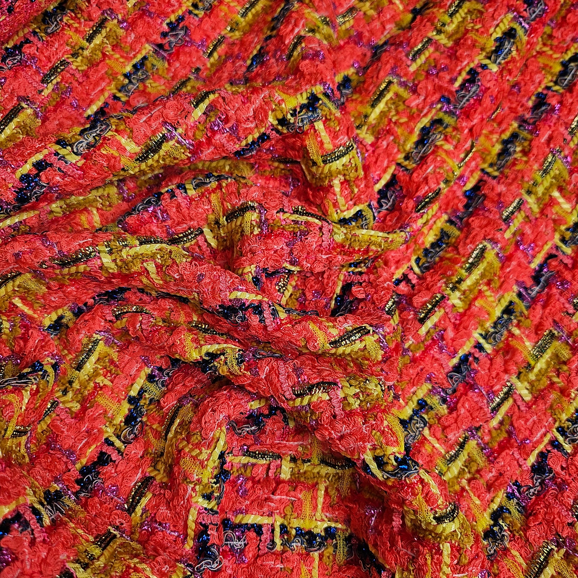 Red, yellow, and black textured tweed fabric with metallic threads, 150cm wide.