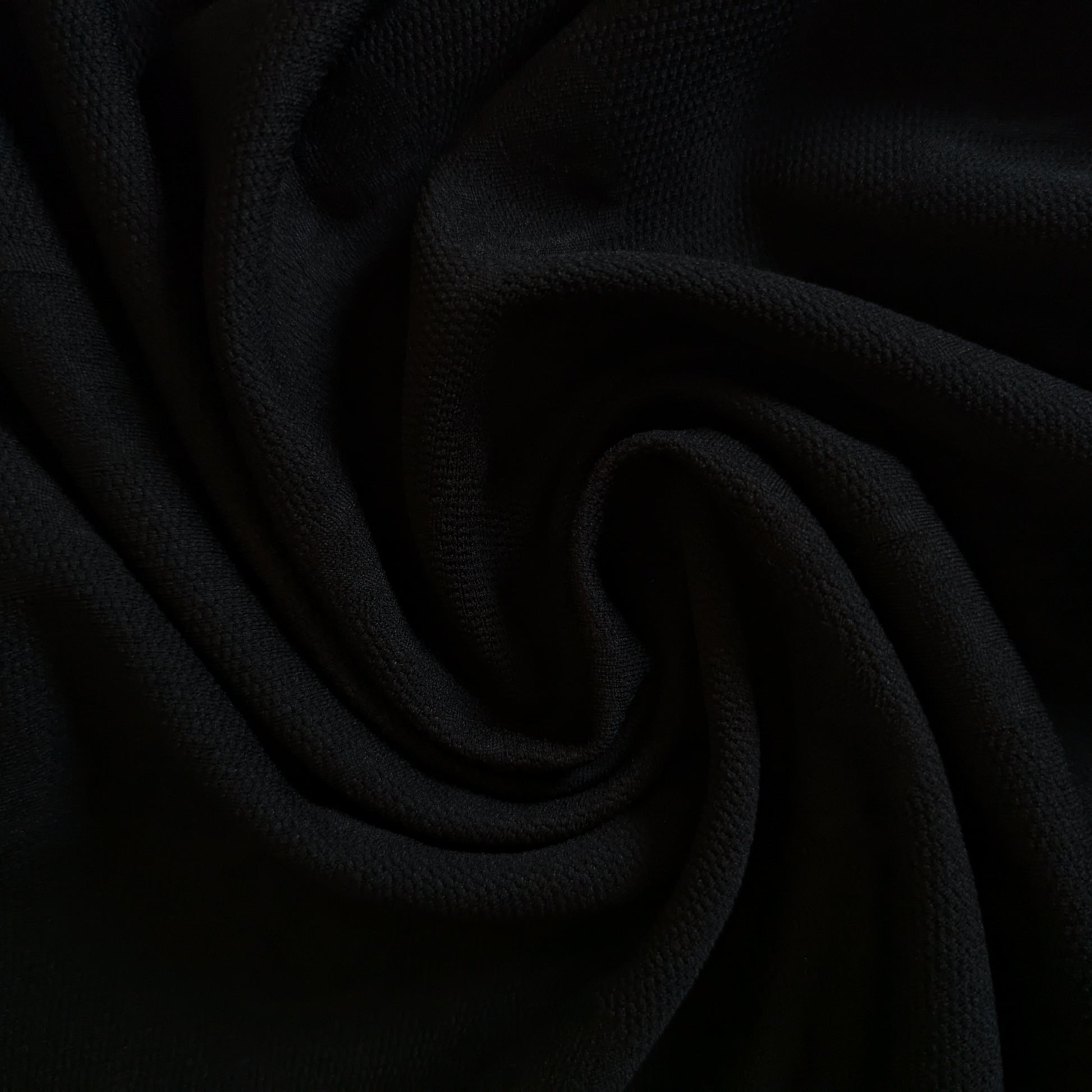 Black G*cci polyester jacquard fabric, subtly textured with an elegant drape, perfect for apparel.