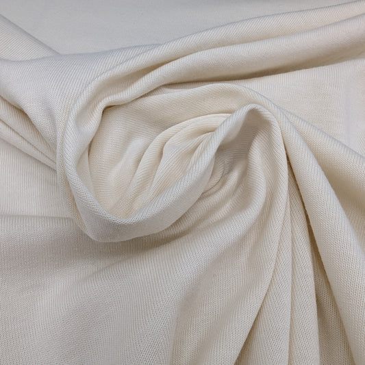 Deadstock D*or natural white cotton jersey fabric, 155 cm wide, with soft folds.