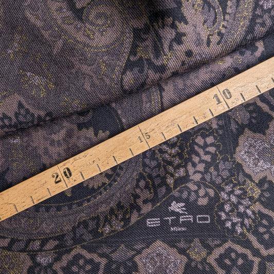 Etro deadstock wool-cashmere-silk fabric with dark paisley pattern, gold accents, and logo, measured by a ruler.