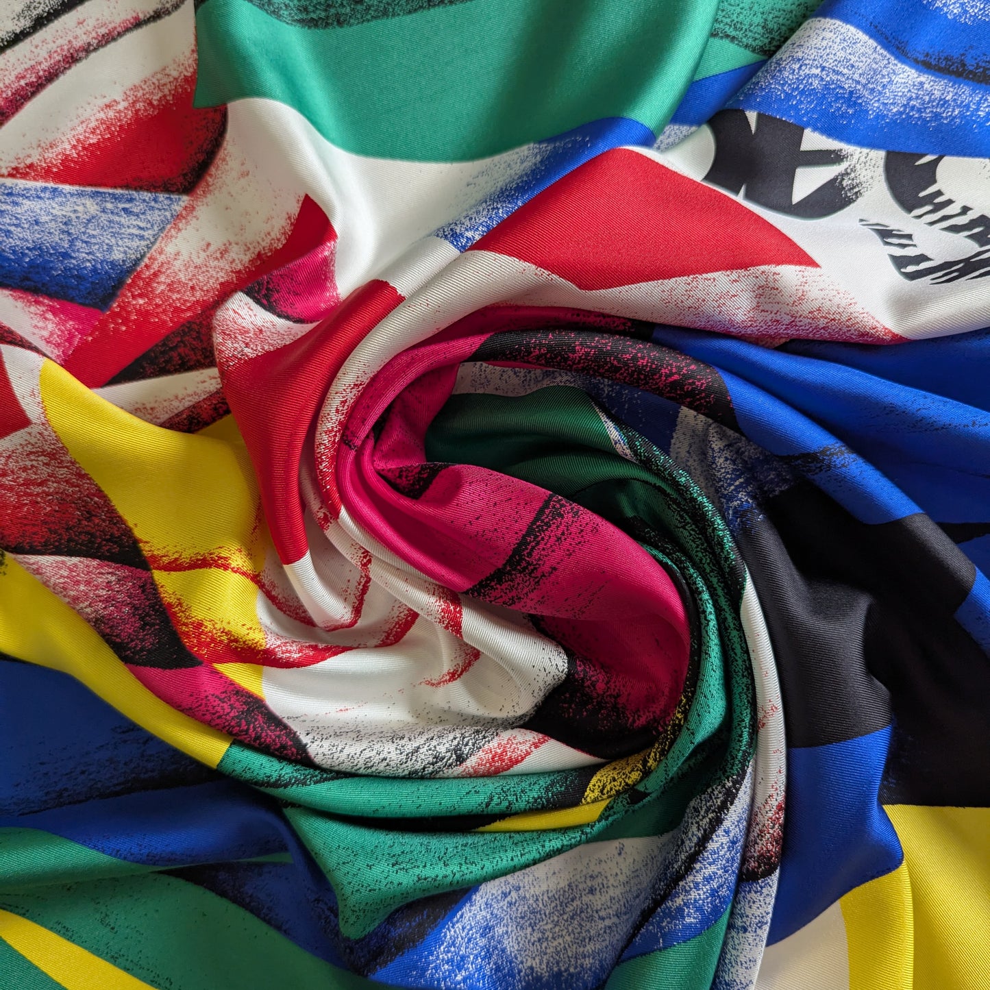Deadstock Versace silk fabric, 140cm wide, with a vibrant, multicolored XXL abstract print and logo.
